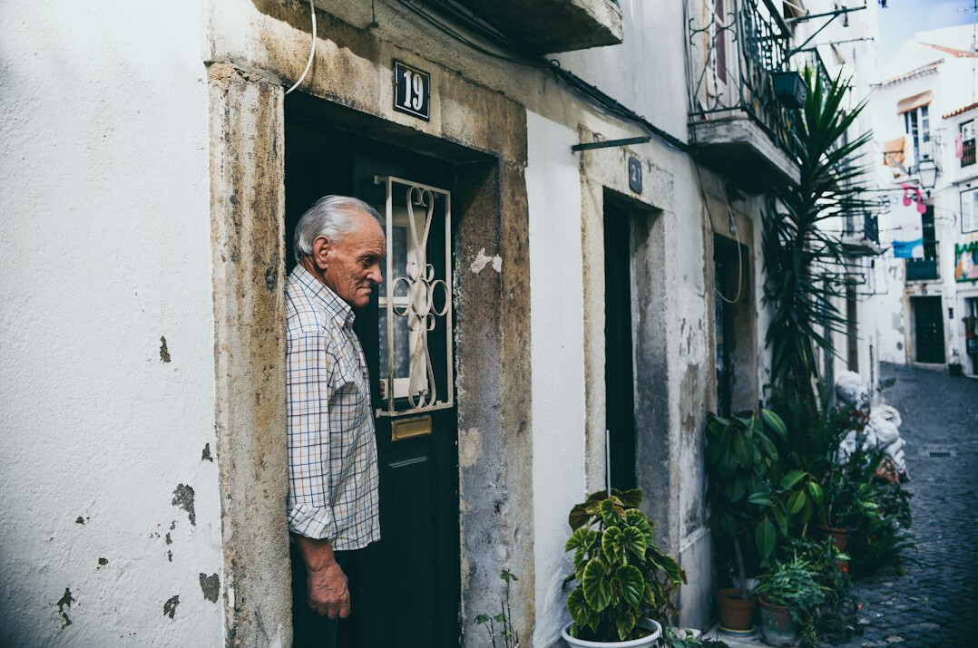 Young Chilean man reading a handwritten letter on a doorstep