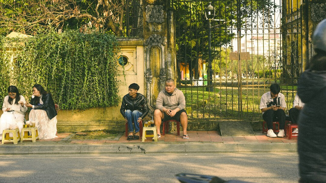 Two women chatting on a street corner in a Chilean neighborhood