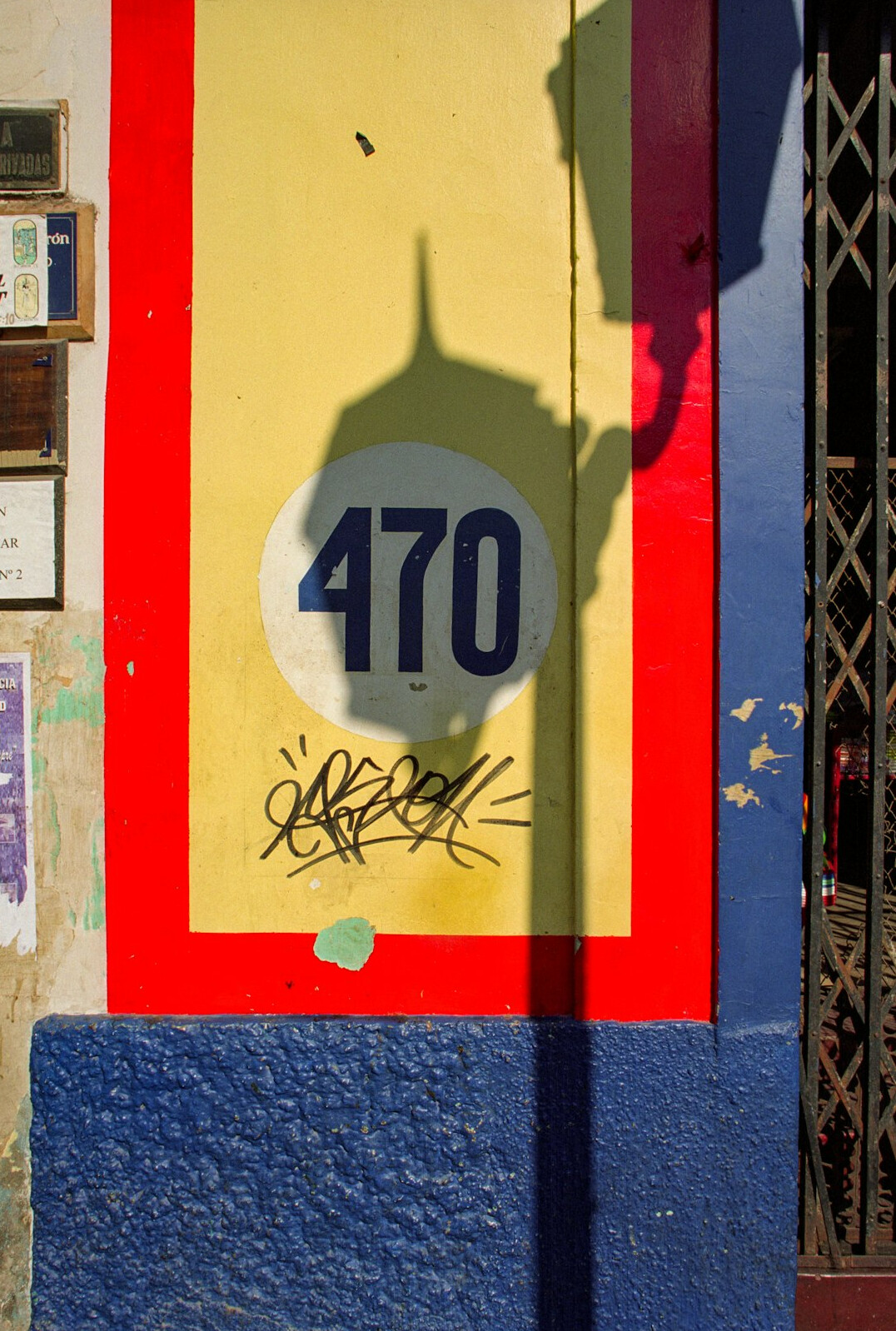 Weathered mailbox and painted door of a house in a Chilean neighborhood